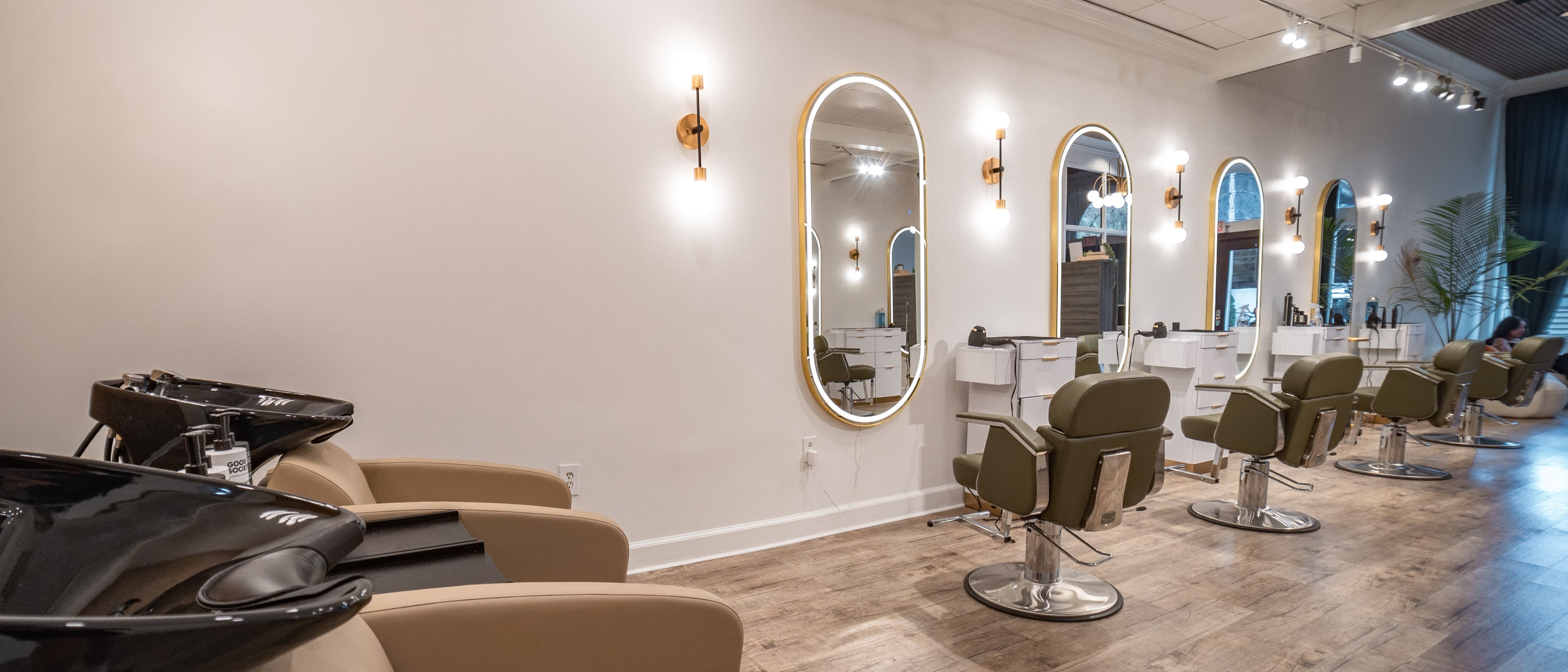Salon interior with chairs, mirrors, and a counter.